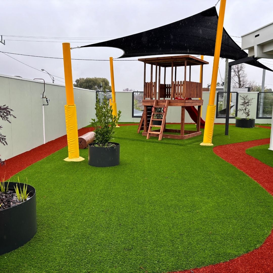artificial grass with childrens play equipment